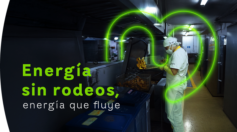 Funcionario de EPM Comercializadora trabajando en cocina industrial con gráfica neón de energía al fondo